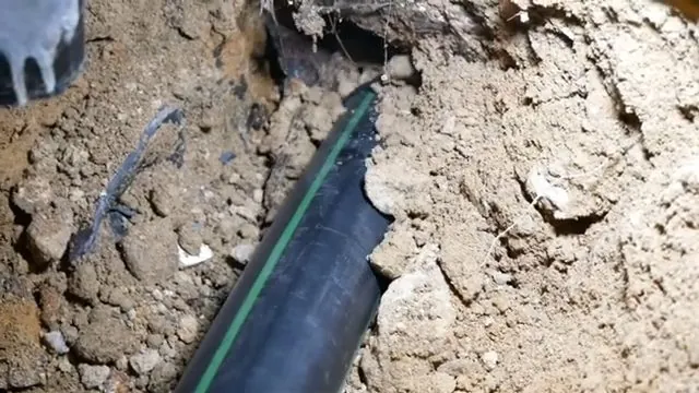 The new black sewer pipe installed in slab trench, part of a Federal Way area plumbing repair.